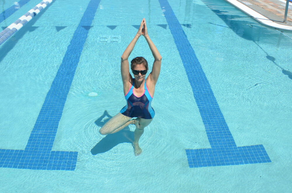 woman doing yoga in the pool