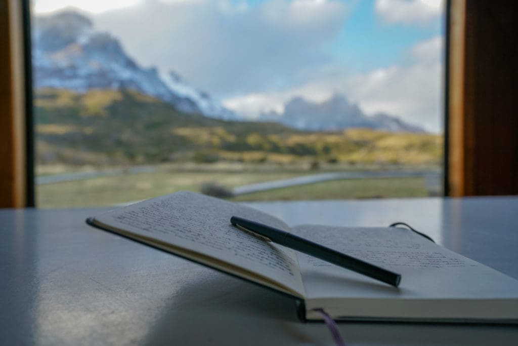 diary open with view of the mountains on the background