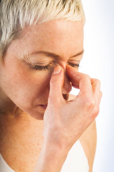 nose pain and headaches woman with sinus headache