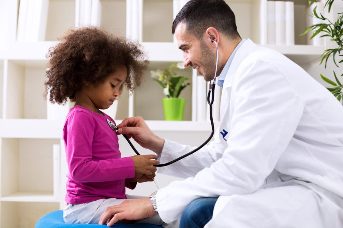 pain in vulnerable populations pediatrician talking to a young girl