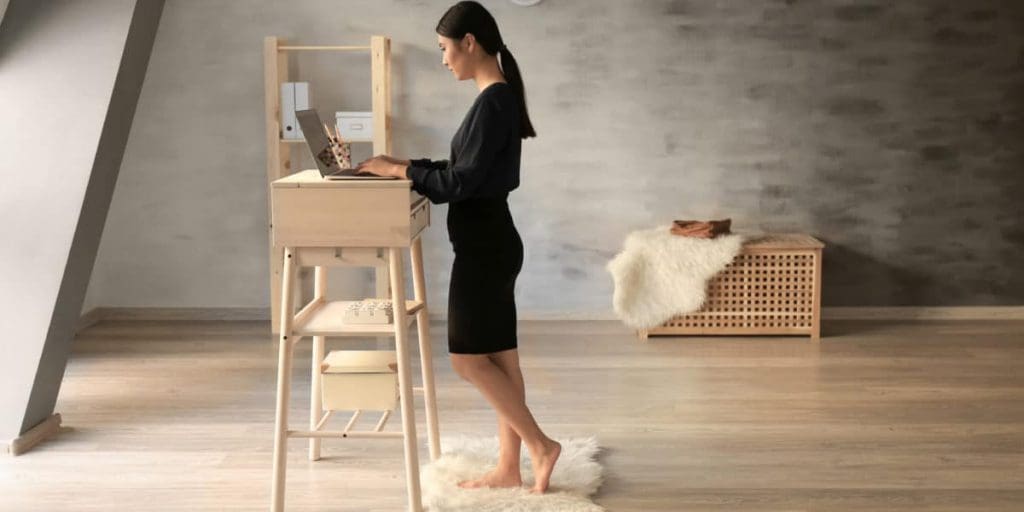relieve work-related shoulder pain woman at standing desk